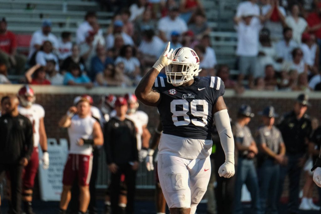 JJ Pegues throws up the fins up sign during a football game against Troy; horizontal image